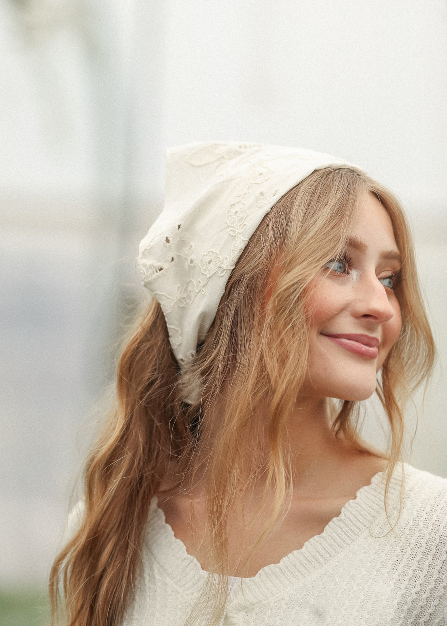 Ivory cotton floral embroidered scarf styled with loose waves and a cream knit sweater.