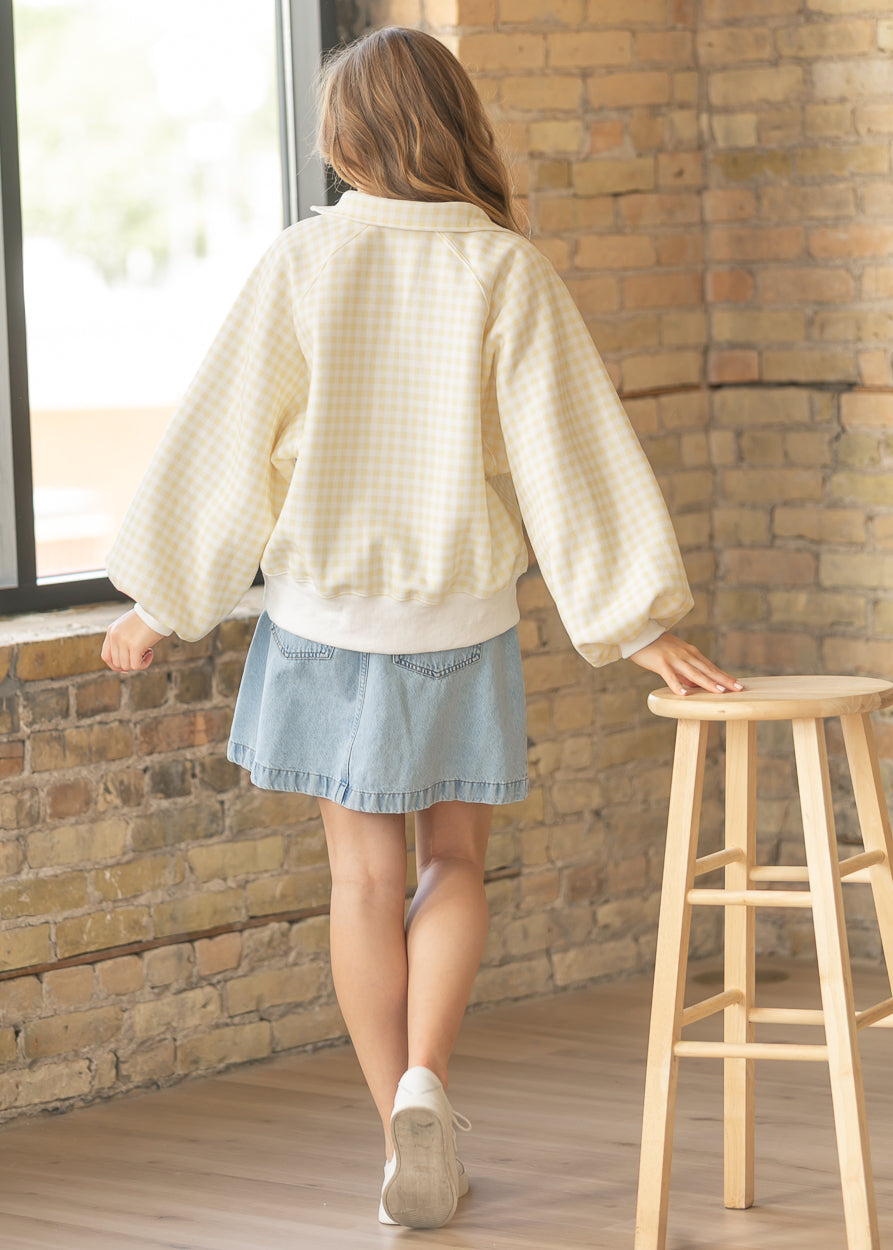Yellow gingham quarter snap sweatshirt with ribbed cuffs and soft casual silhouette.