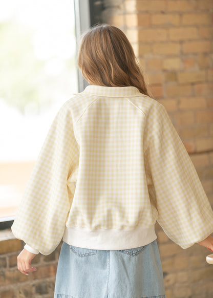 Back view of yellow gingham pullover showing relaxed oversized fit and raglan sleeve construction.