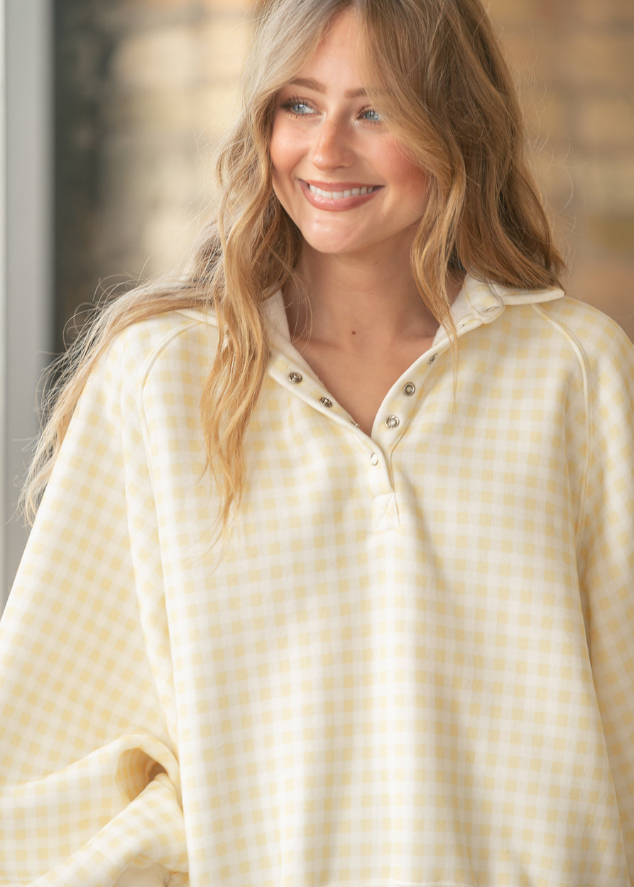 Front view of PaperMoon gingham snap pullover styled with a light wash denim skirt.