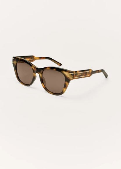 Angled view of tortoise polarized sunglasses with gold-tone temple detailing.