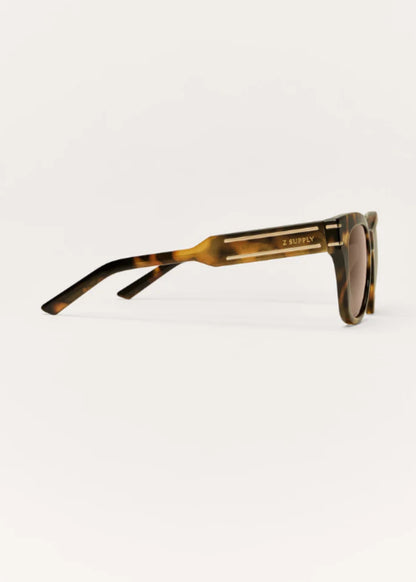 Side profile of tortoise polarized sunglasses with gold-tone accent details.