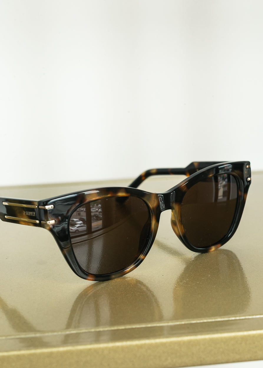 Close-up of Z Supply tortoise sunglasses featuring gold-tone temple detailing.