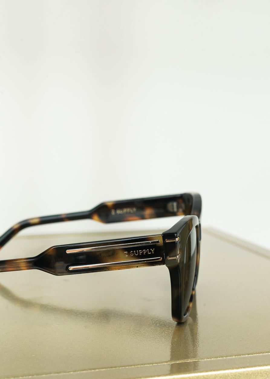 Close-up of Z Supply tortoise sunglasses featuring gold-tone temple detailing.