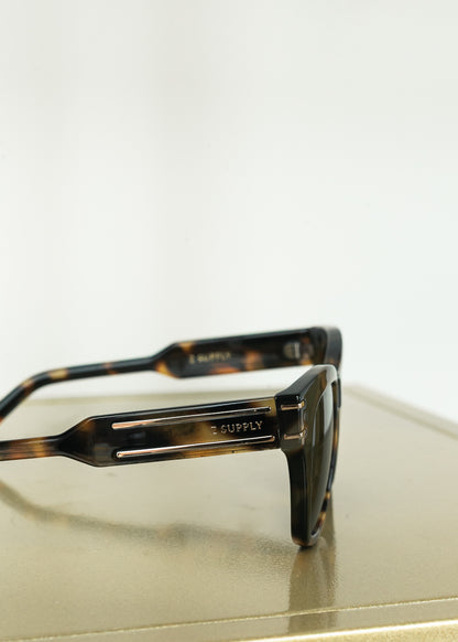 Close-up of Z Supply tortoise sunglasses featuring gold-tone temple detailing.