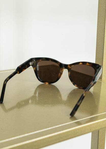 Angled view of tortoise sunglasses showing medium square silhouette.