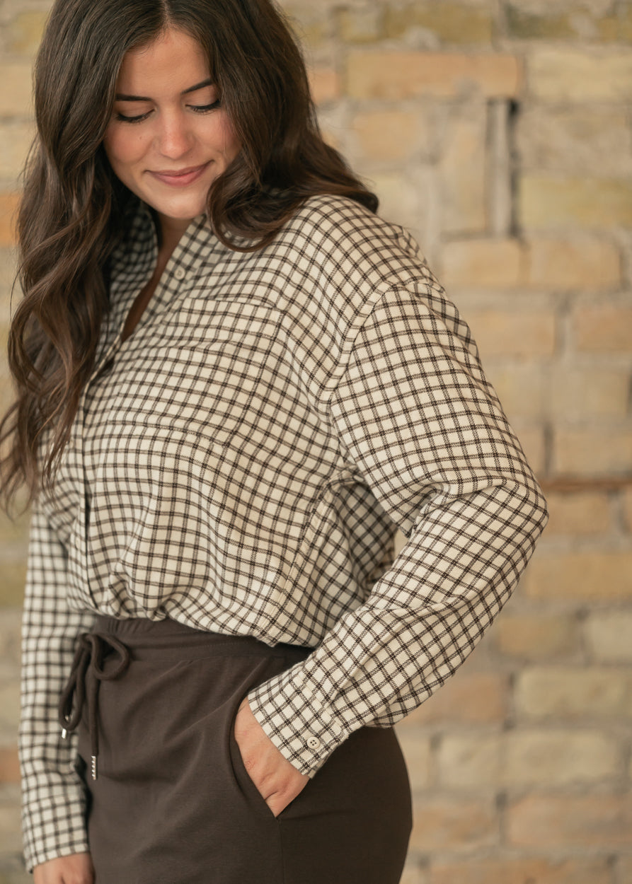 Cream and chocolate plaid button-up top with long sleeves and button cuffs, styled with a chocolate midi skirt.