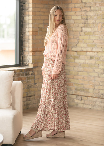 Ivory floral maxi skirt with stretchy waistband and feminine tiered design.