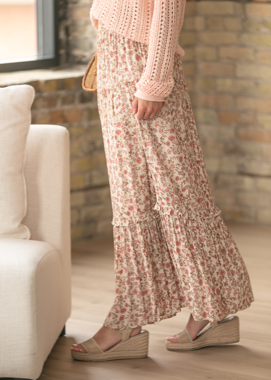 Floral maxi skirt styled with a blush knit sweater and woven crossbody bag.