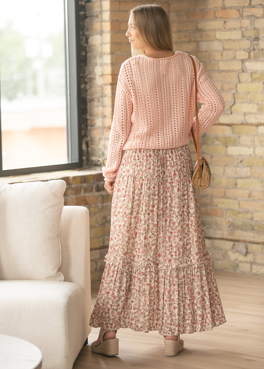 Back view of floral maxi skirt showing flowy silhouette and tiered ruffle accents.