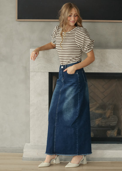 Brown striped short sleeve tee styled with a dark wash denim maxi skirt and neutral flats.