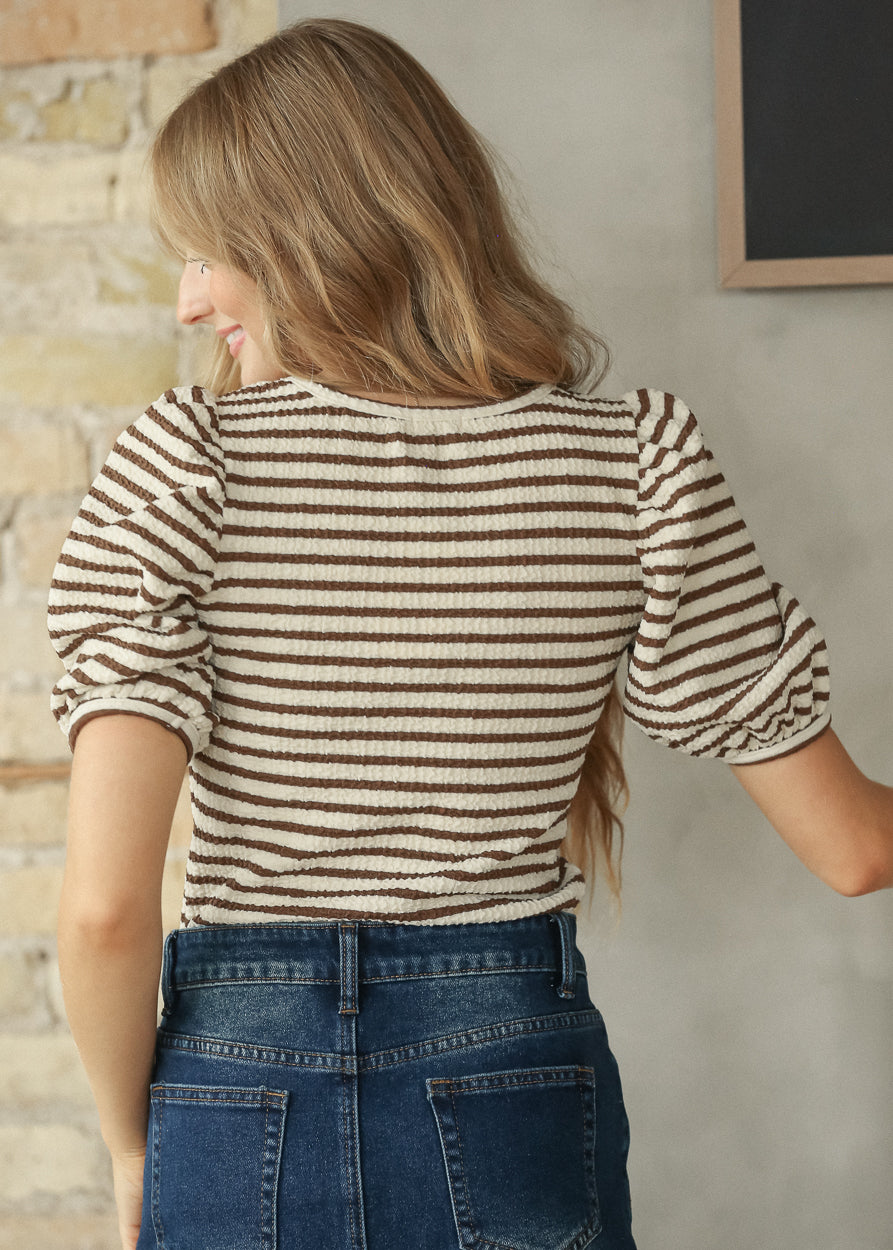 Back view of brown and cream striped tee showing the short sleeves and striped pattern.