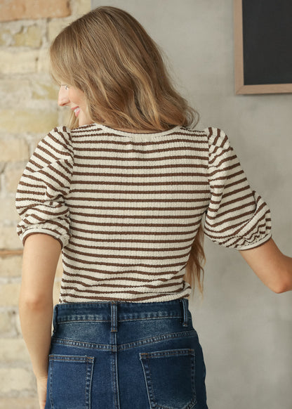 Back view of brown and cream striped tee showing the short sleeves and striped pattern.