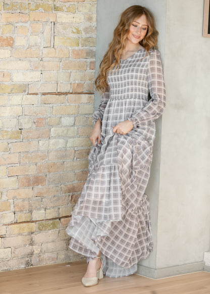 Taupe plaid maxi dress spun out to show the full tiered skirt and floor-length hem.