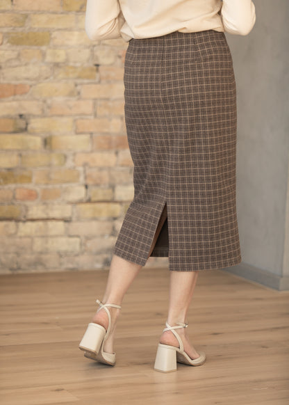 Back of brown plaid midi pencil skirt showing center back slit and tailored fit.