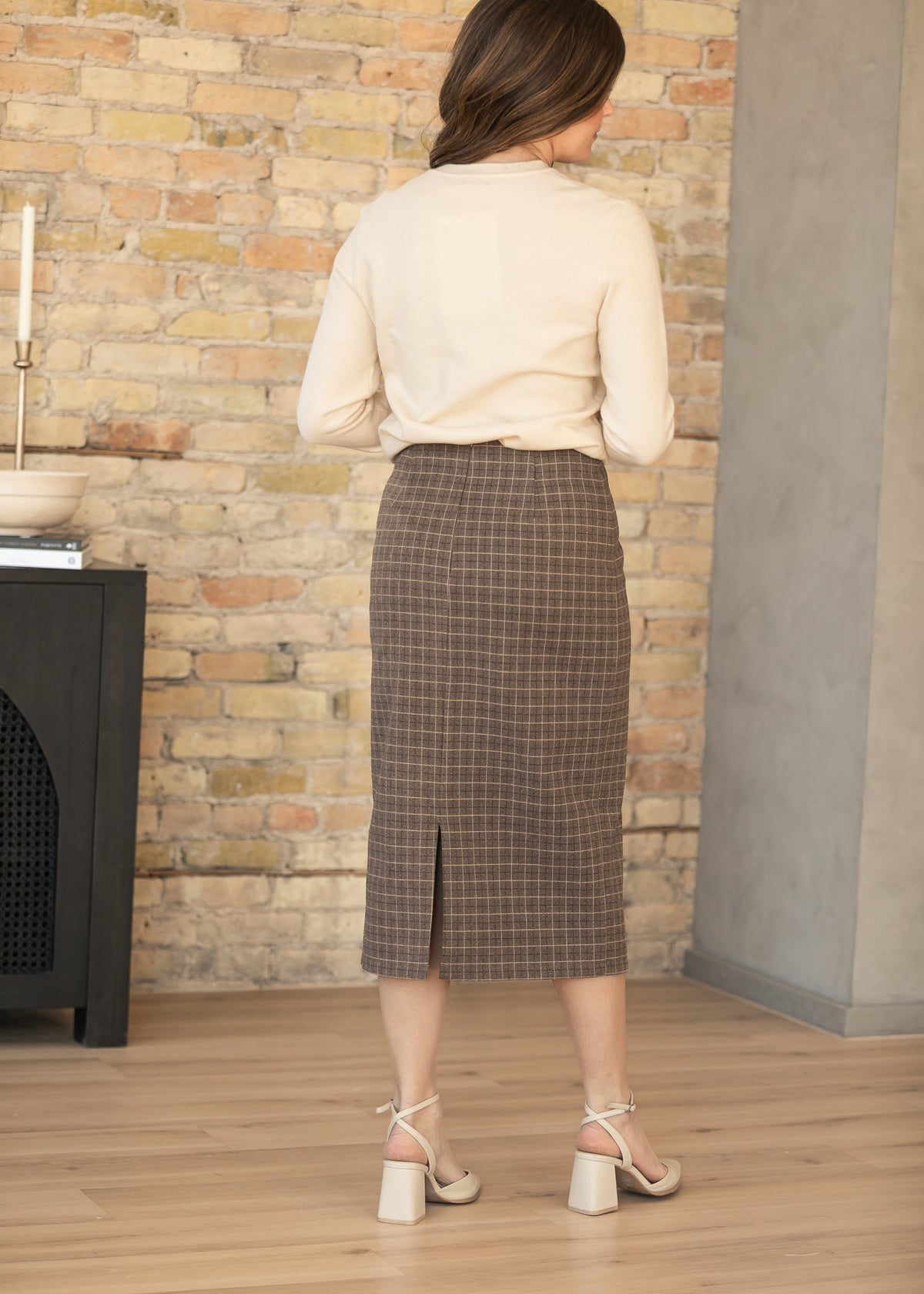 Full back view of brown plaid wool midi skirt with classic windowpane plaid pattern.
