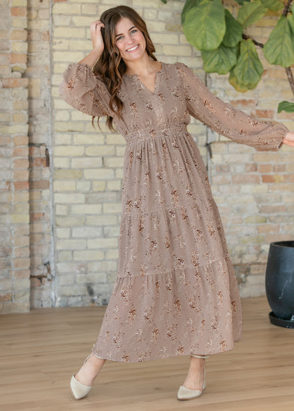 Celia brown floral maxi dress with long sleeves and flowing skirt shown in motion.