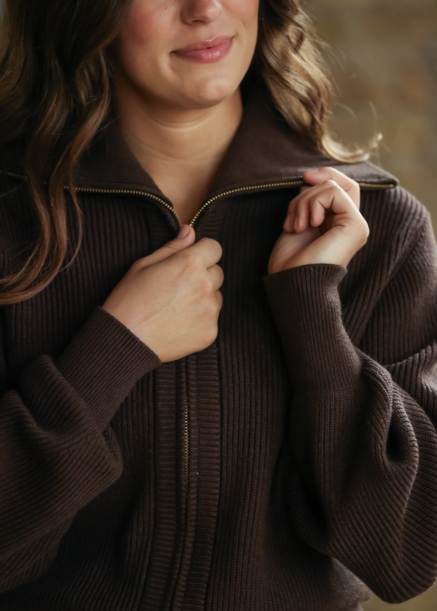 Brown ribbed knit jacket shown from the back with hip-length hem