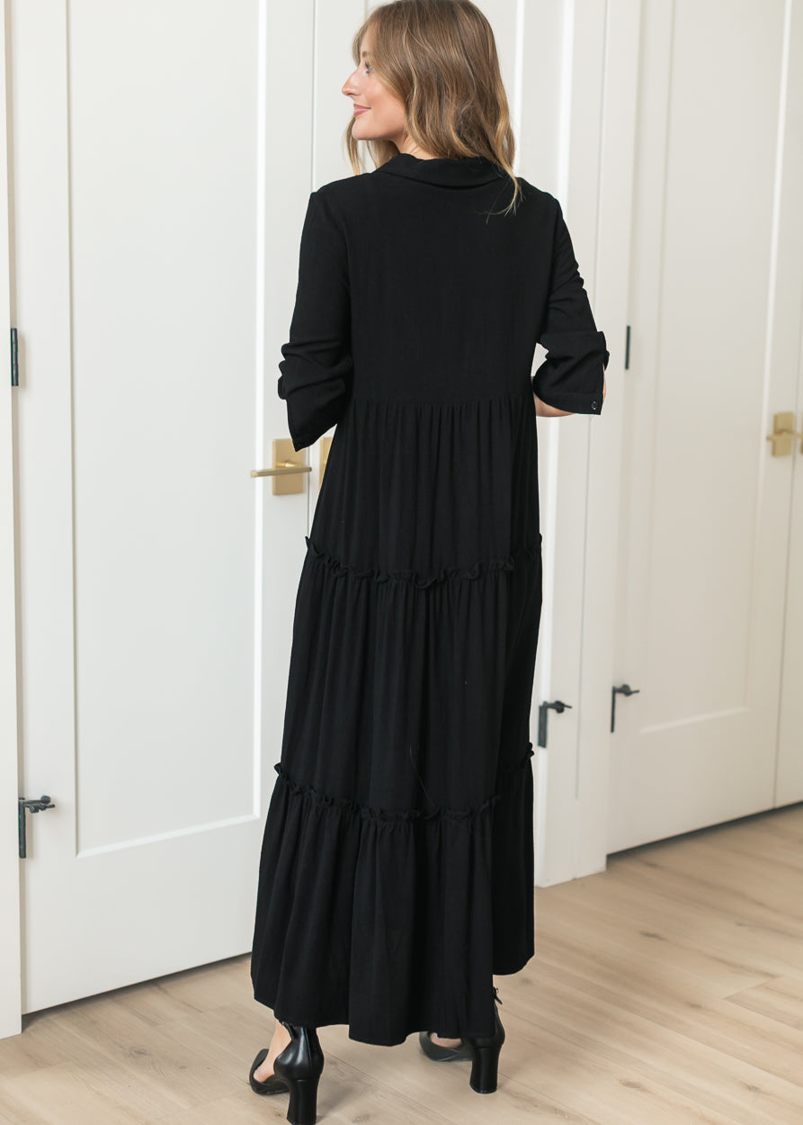 Back of black Elsie midi dress showing the half sleeves and calf-length hem.
