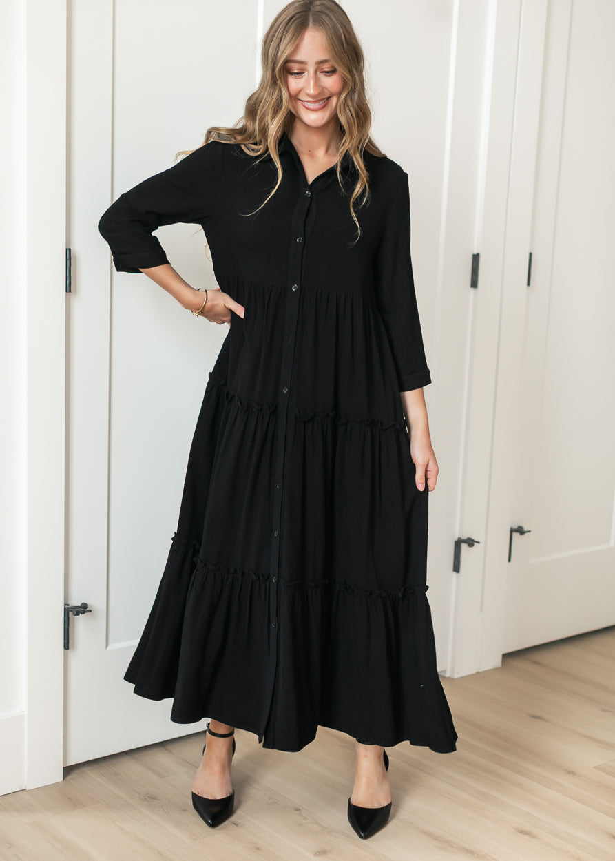 Black Elsie midi dress on 5'7" model showing the calf-length hem and A-line silhouette.