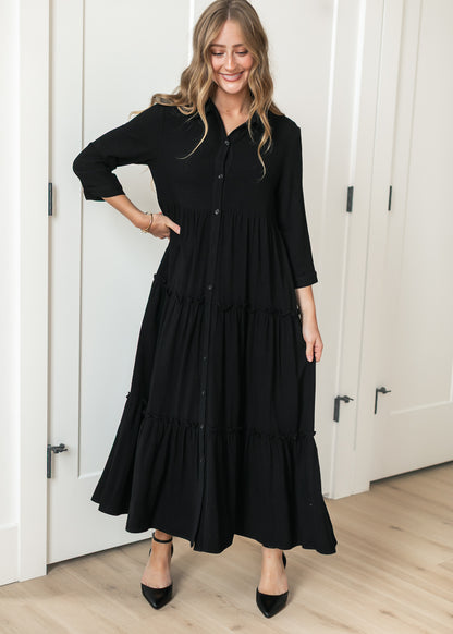 Black Elsie midi dress on 5'7" model showing the calf-length hem and A-line silhouette.
