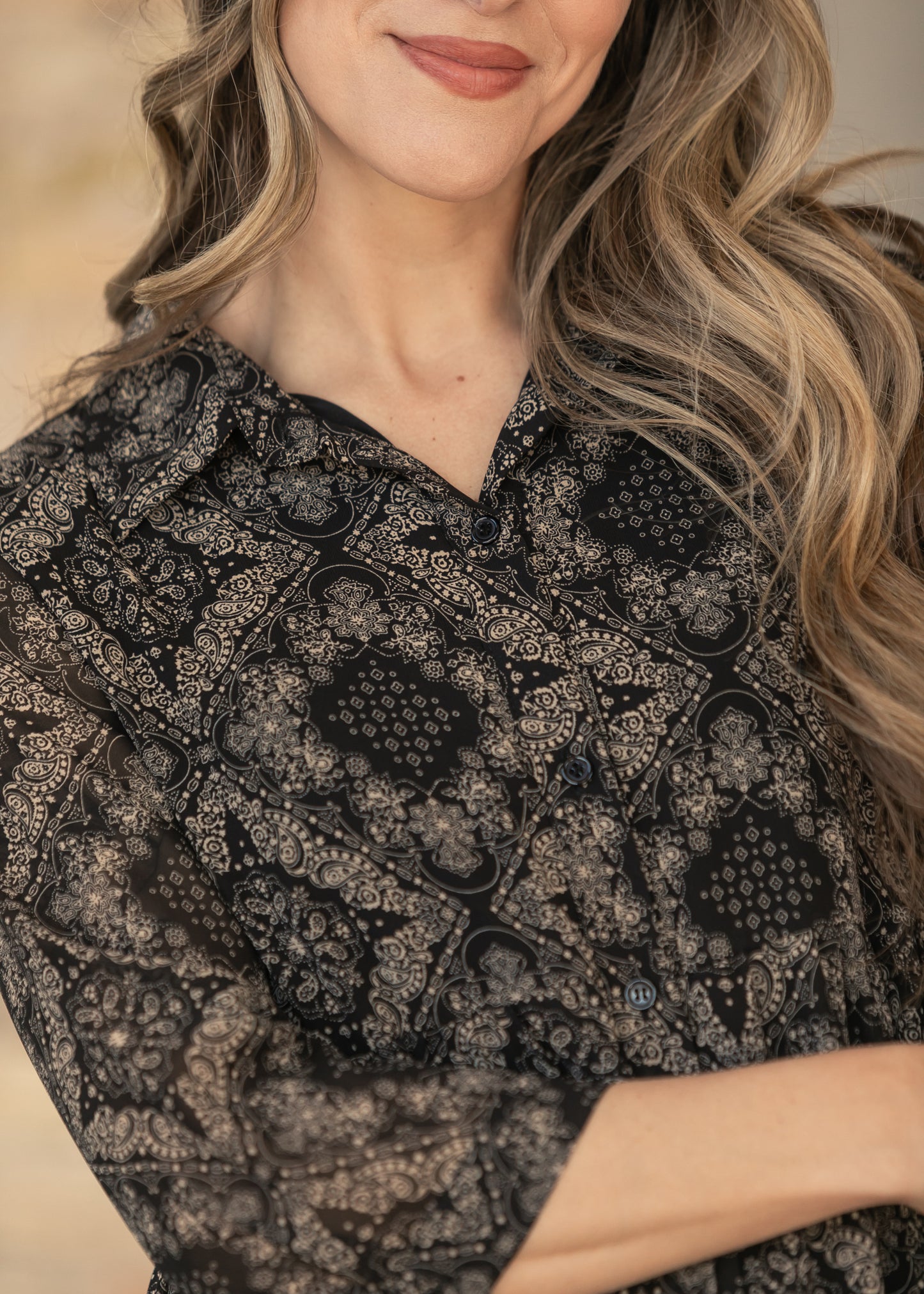 Close-up of Elsie paisley dress showing the V-neck and half sleeve.