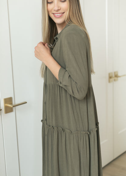 Side view of olive midi dress showing the half sleeves and tiered A-line shape.