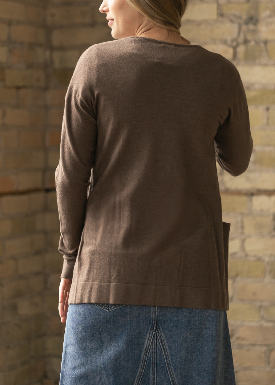 Back view of the coffee short cardigan showing the relaxed hem and back pocket.