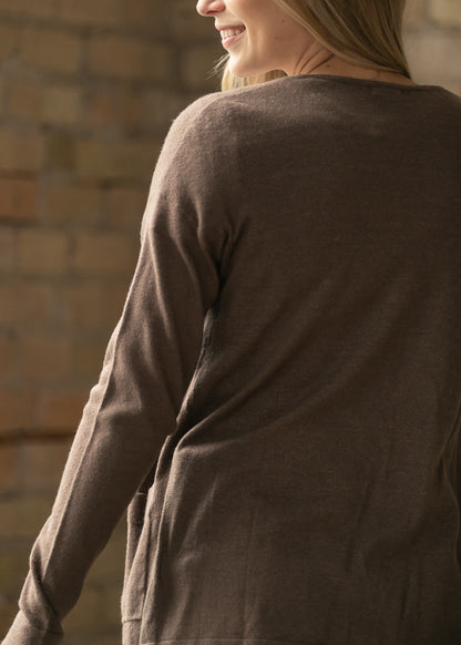 Back view of the coffee short cardigan showing the relaxed hem and back pocket.