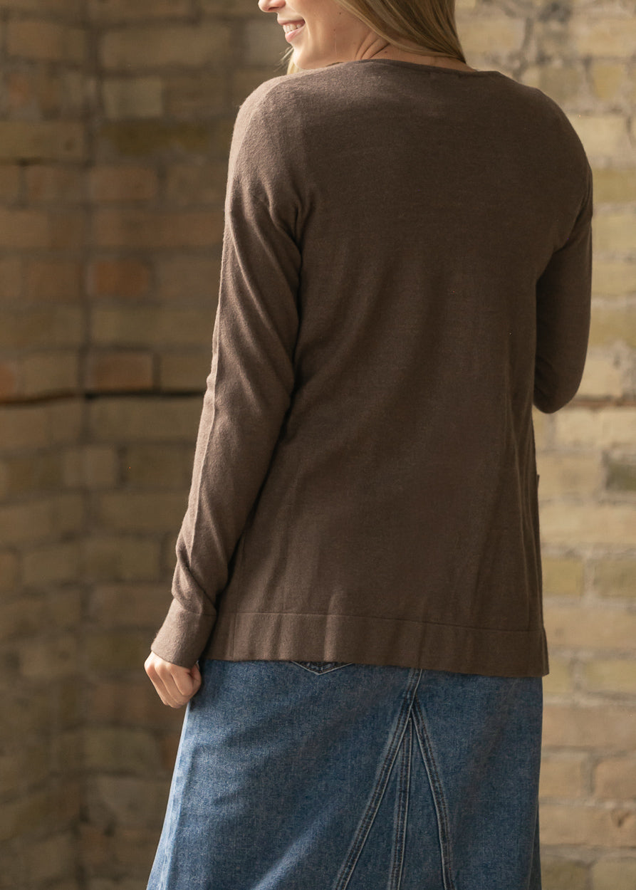 Back view of the coffee short cardigan showing the relaxed hem and back pocket.