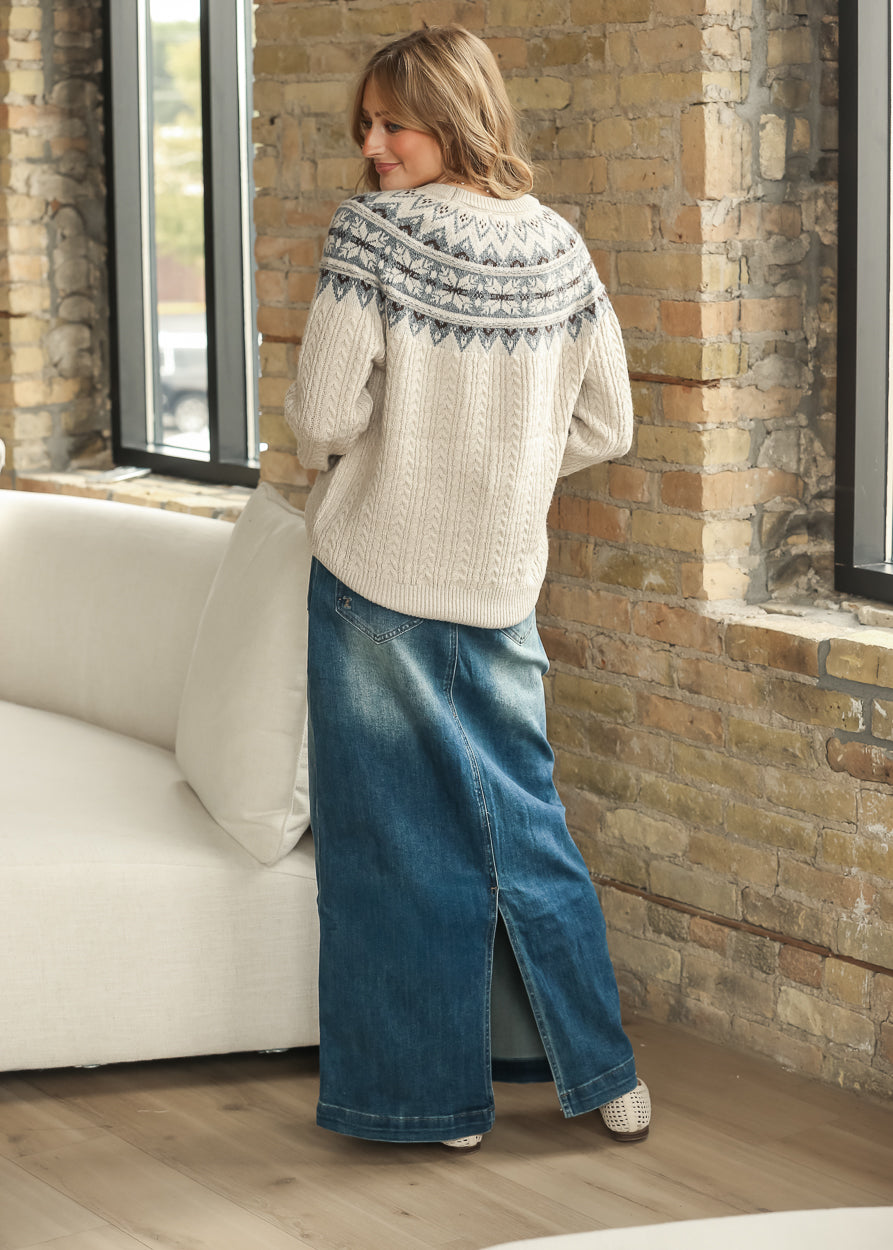 Full-length back view of cream Fair Isle sweater styled with a denim maxi skirt