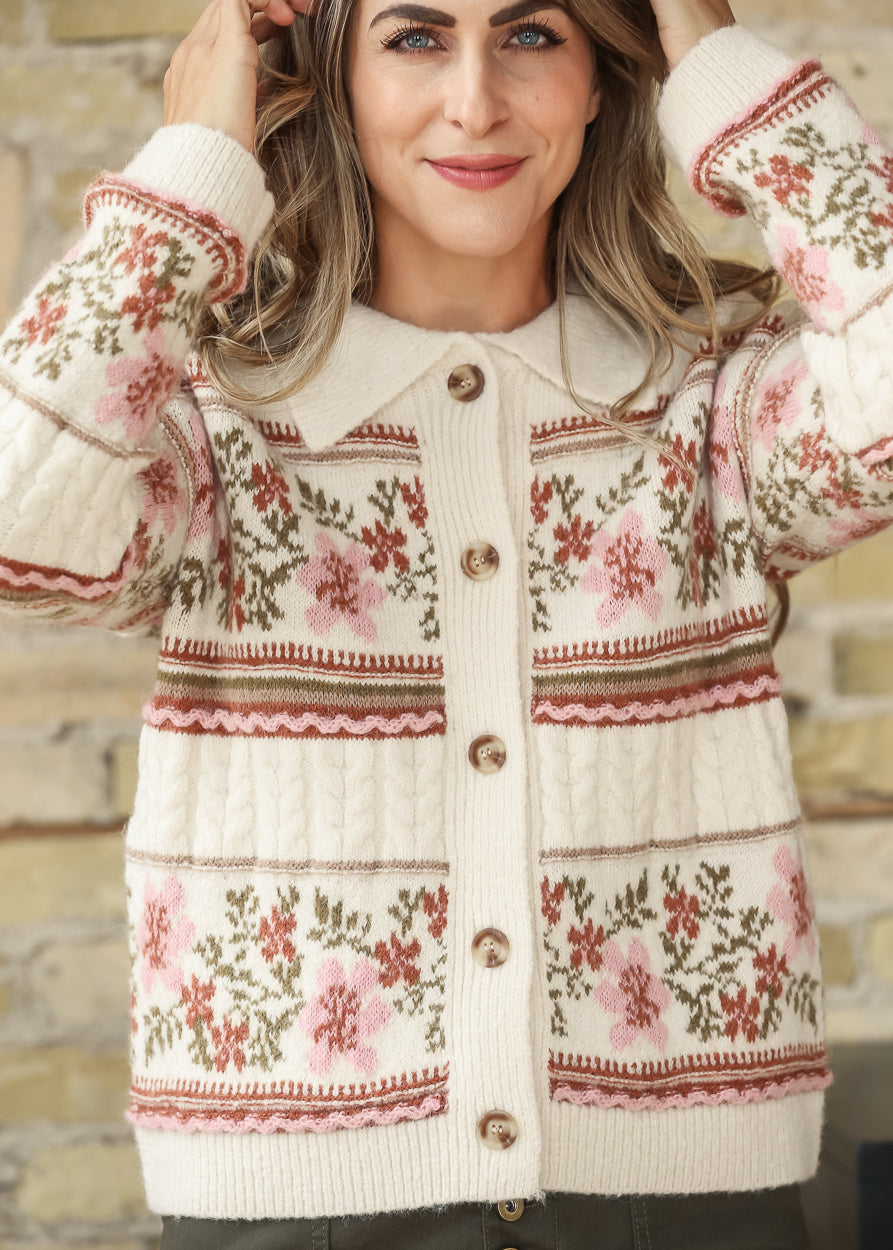 Close-up front view of cream floral cardigan showing knit pattern and buttons