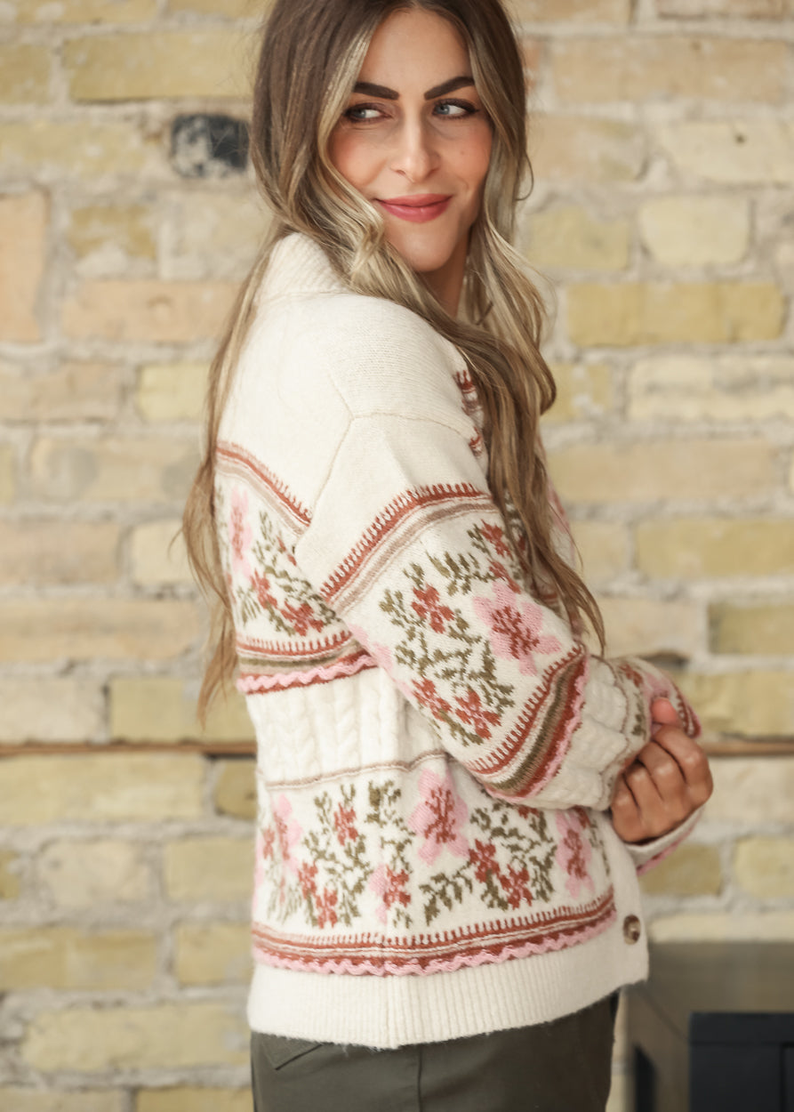 Model wearing a cream floral cardigan with olive skirt, side view