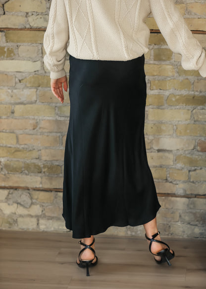 Back view of charcoal faux suede midi skirt styled with a cream sweater