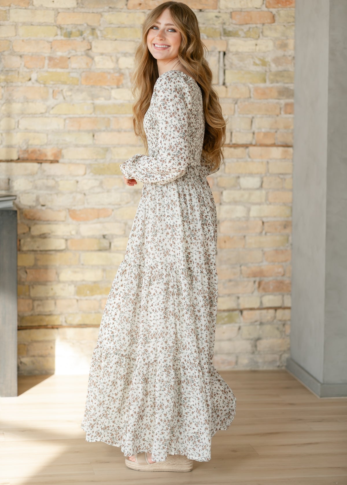 Side view of a floral dress with long sleeves.