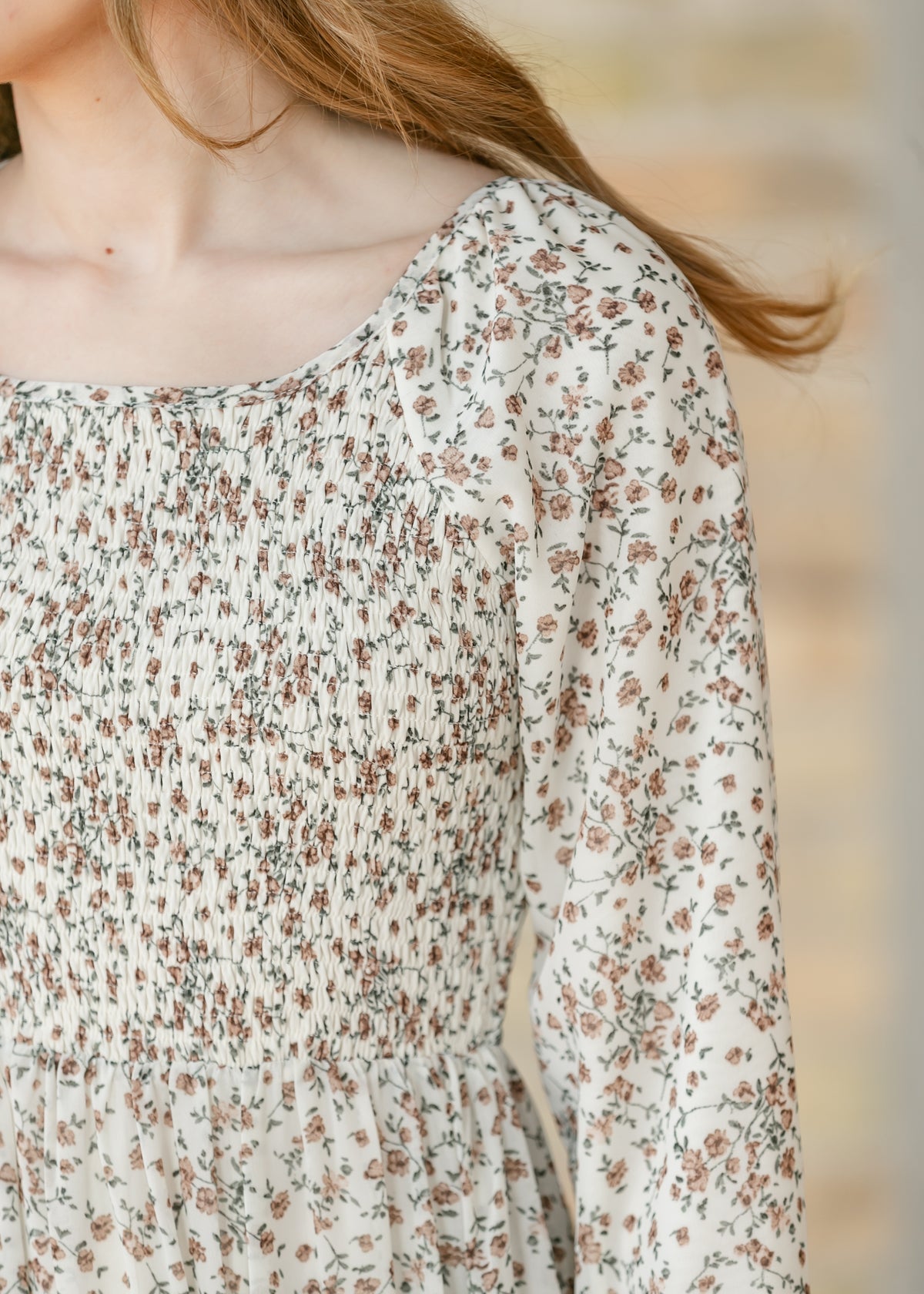 Close-up of the shoulder of a floral dress.