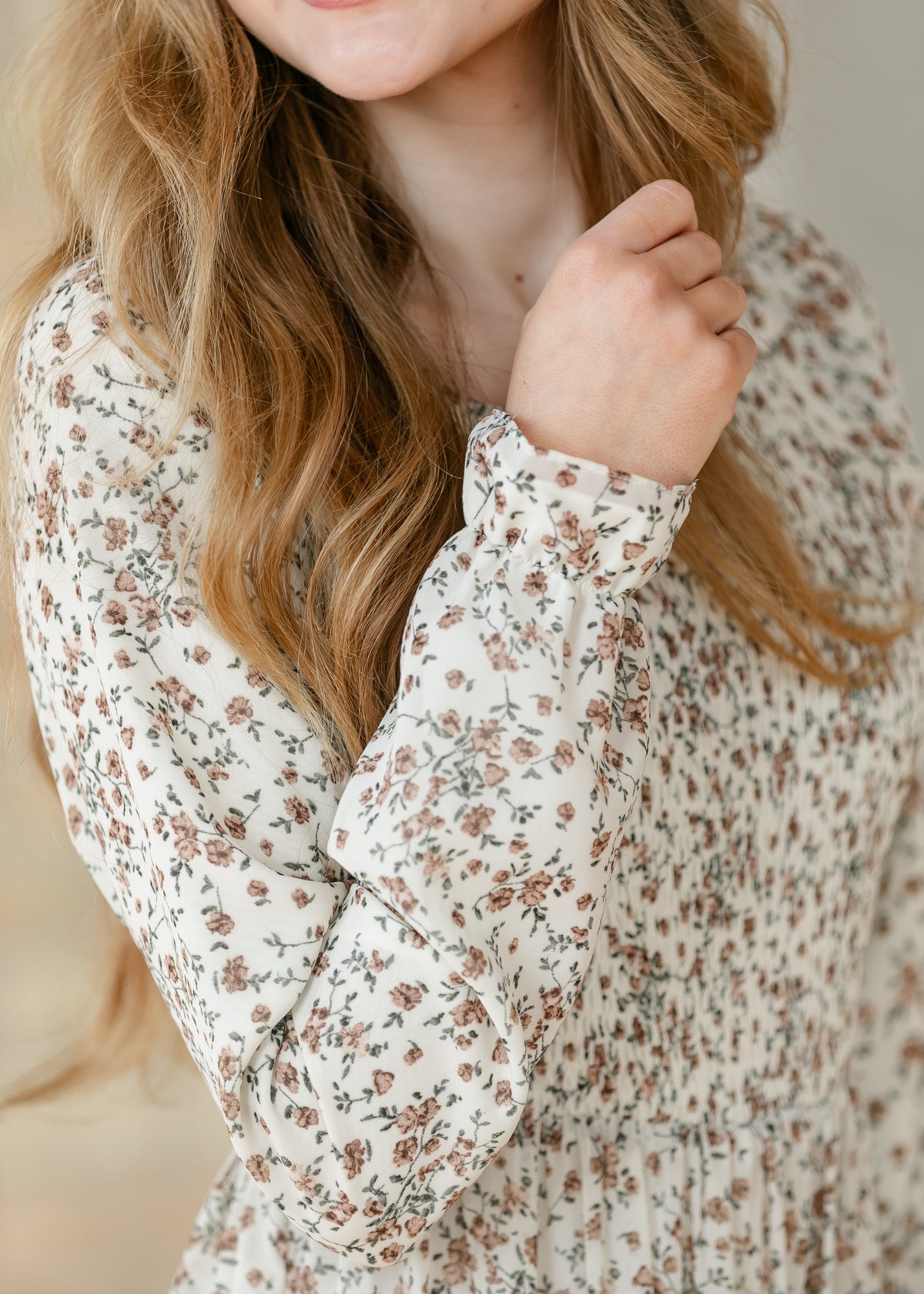 Close-up of the sleeve cuff of a floral dress.