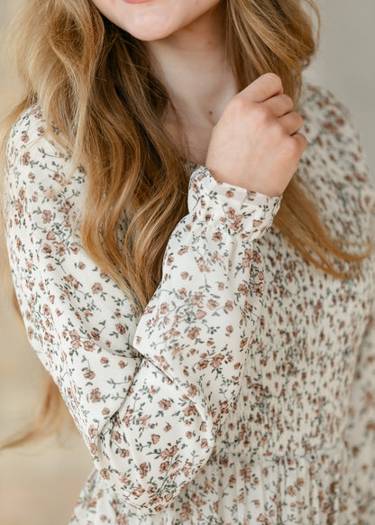 Close-up of the sleeve cuff of a floral dress.