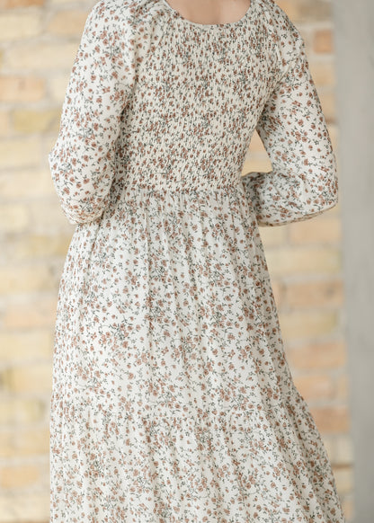 Floral dress with long sleeves  showing the smocked back.