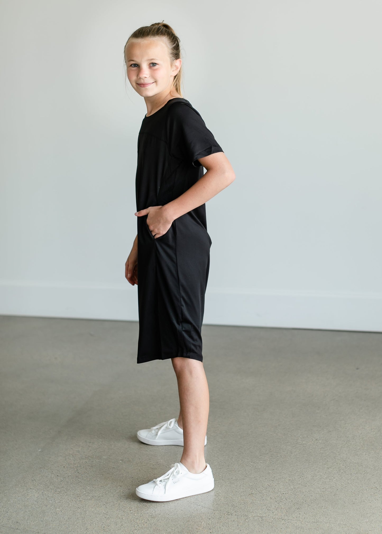 A girl's sized midi sports dress made from quick dry fabric. Comes in black or mauve.