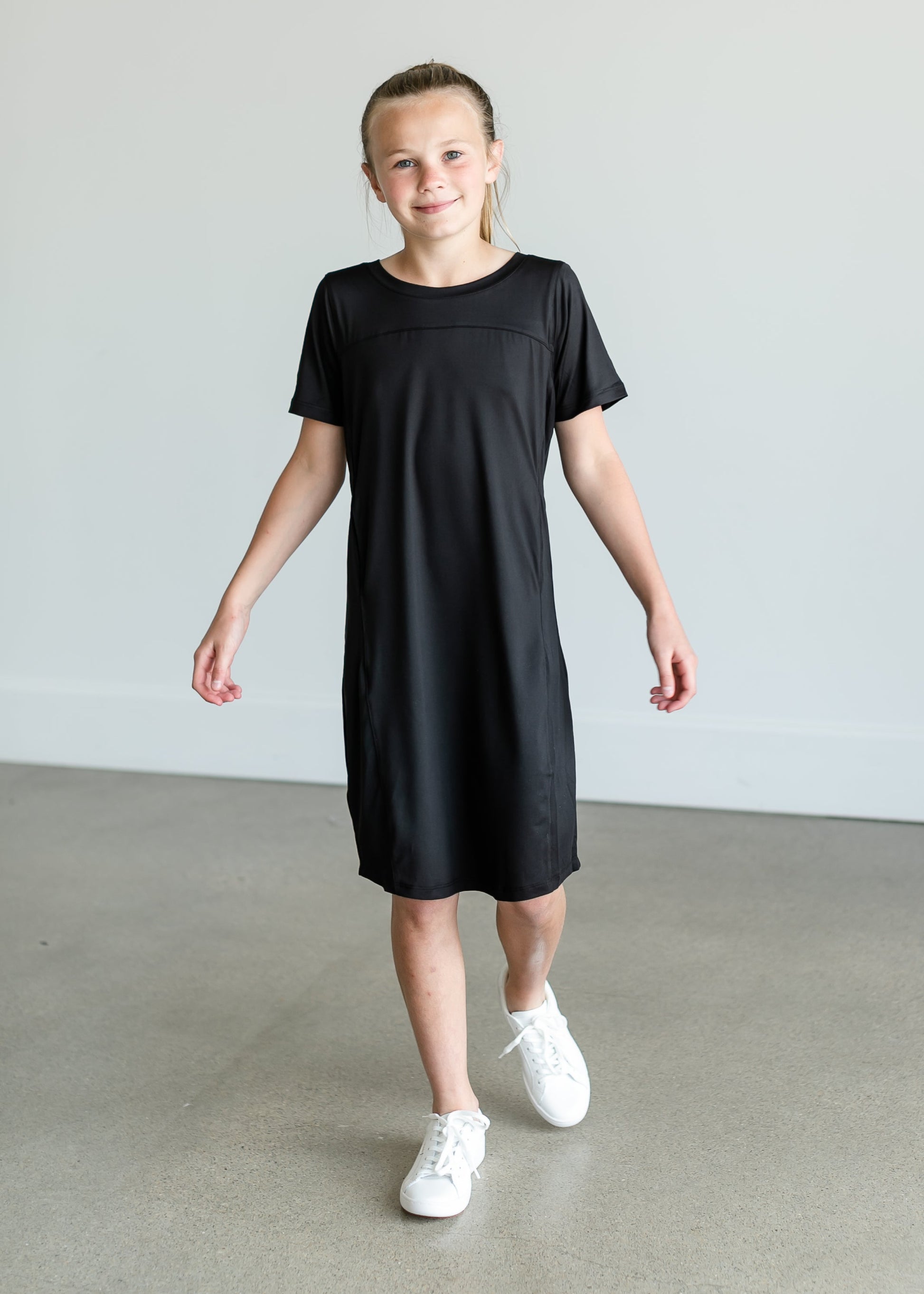 A girl's sized midi sports dress made from quick dry fabric. Comes in black or mauve.