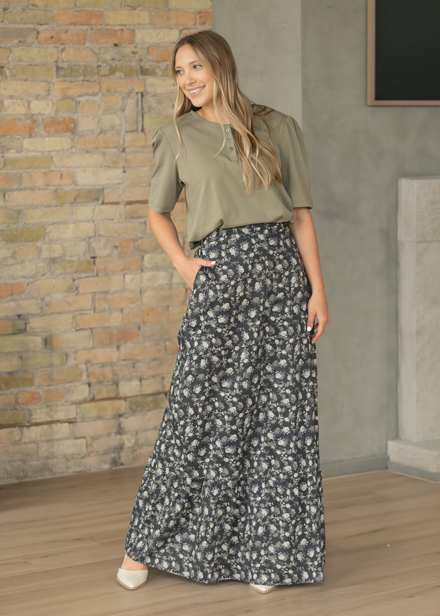 Olive cotton button top with loose fit and elbow-length sleeves, styled with a dark floral maxi skirt.