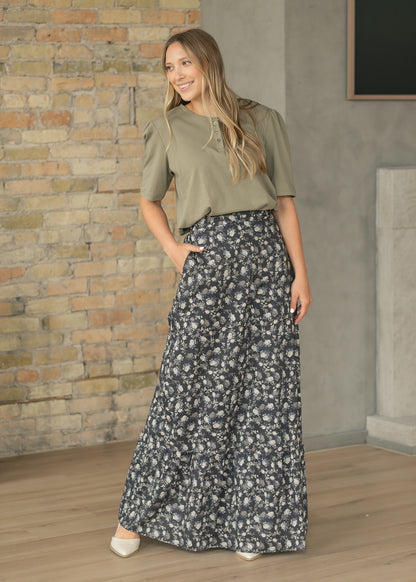 Olive cotton button top with loose fit and elbow-length sleeves, styled with a dark floral maxi skirt.