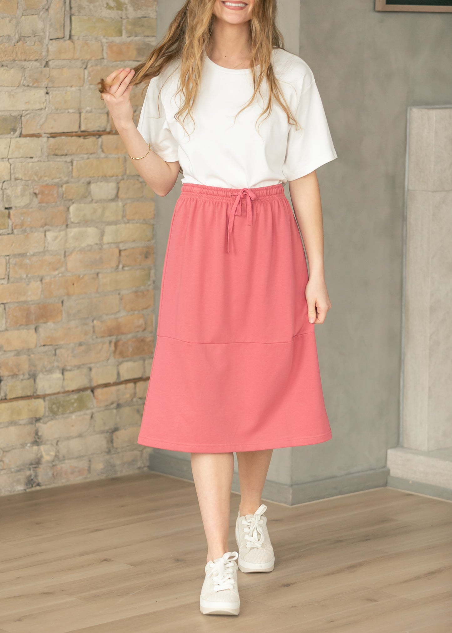 Mulberry sweatshirt midi skirt worn with an oversized white tee and white sneakers.