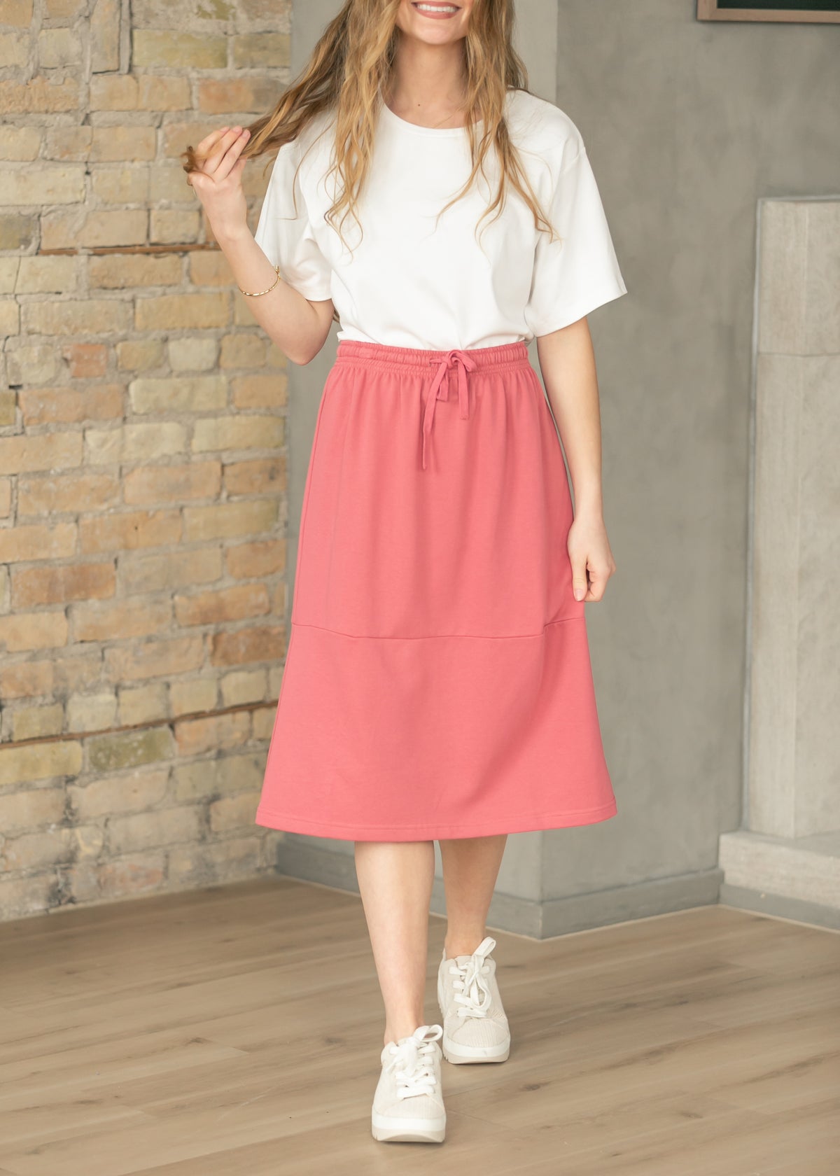 Mulberry sweatshirt midi skirt worn with an oversized white tee and white sneakers.
