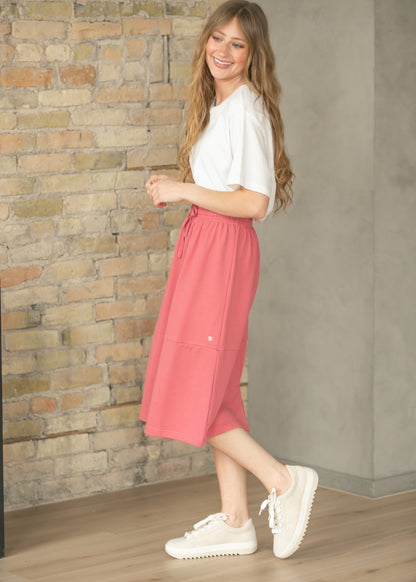 Side view of mulberry sweatshirt midi skirt showing its flowing A-line silhouette.