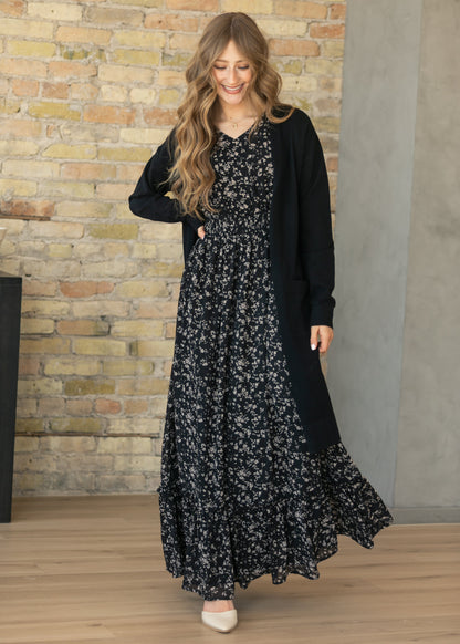 Isabella Black Floral Flutter Sleeve Maxi Dress styled with a black open front cardigan for a modest layered look.