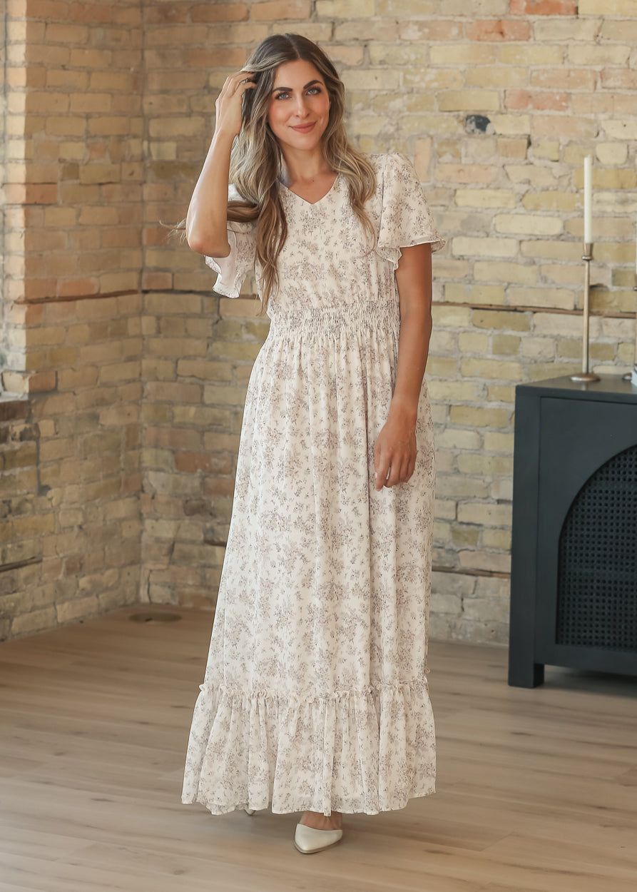 Floral maxi dress with side pockets, styled with ivory heels for an easy, polished look.