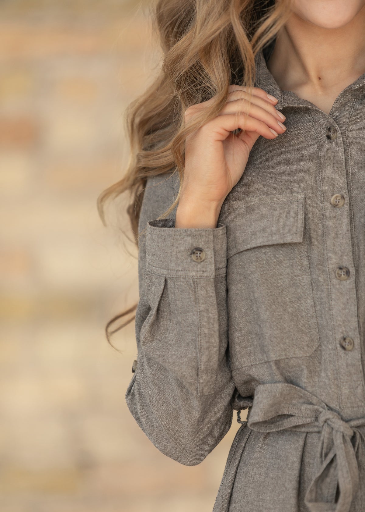 Close-up of sleeve of brown chambray dress.