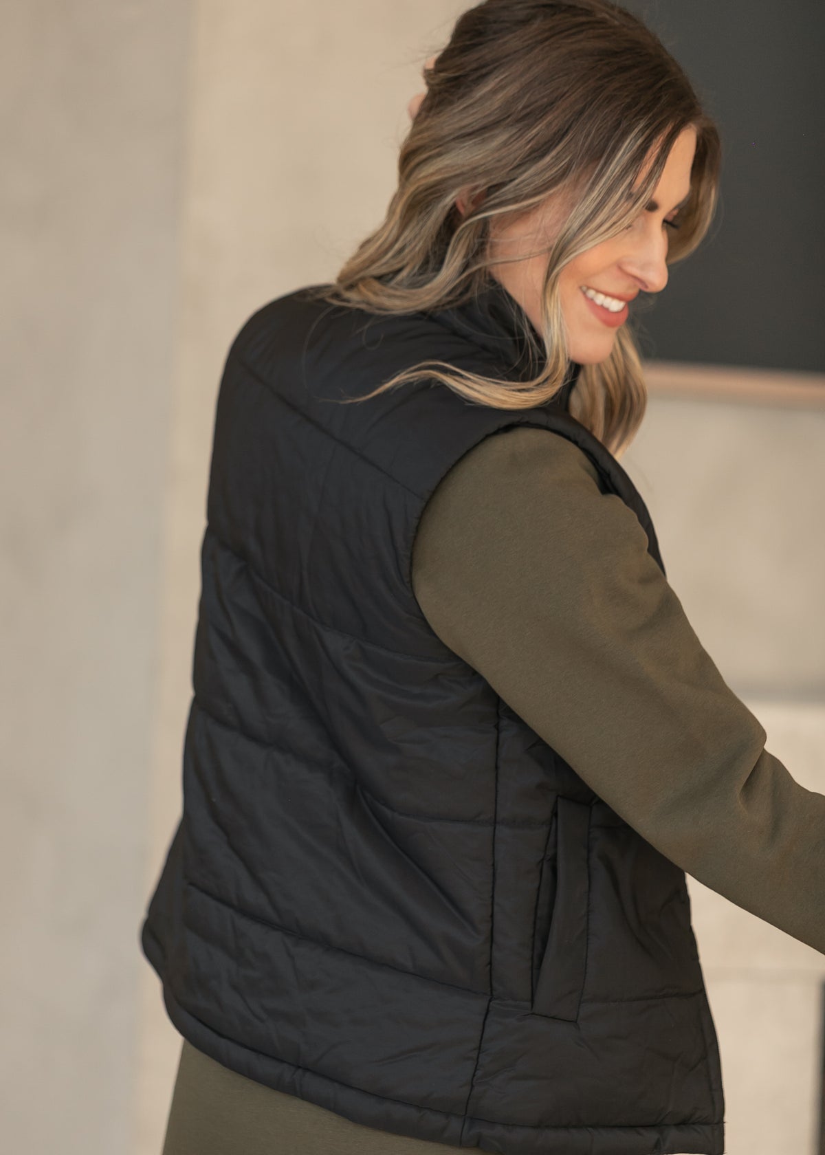 Back view of the Polar Black Puff Vest Short showing the quilted design.